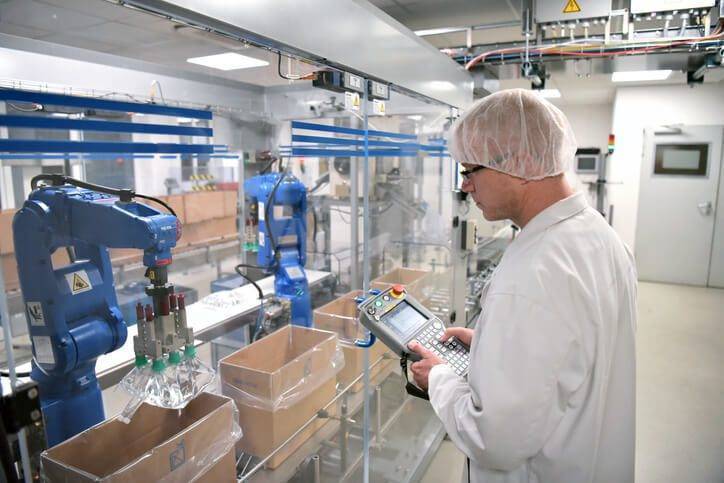 Cleanroom worker watching machinery work