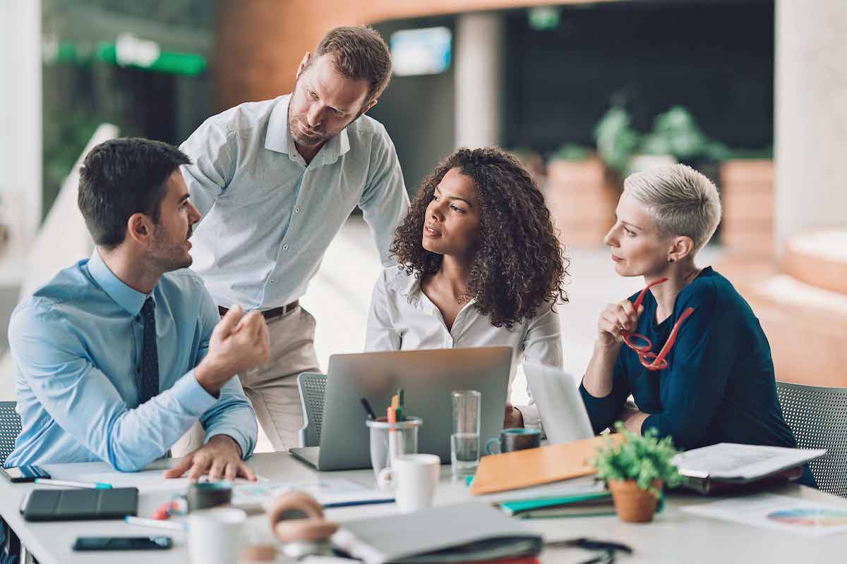 erp selection erp consulting services Group of men and women sitting at a table discussing