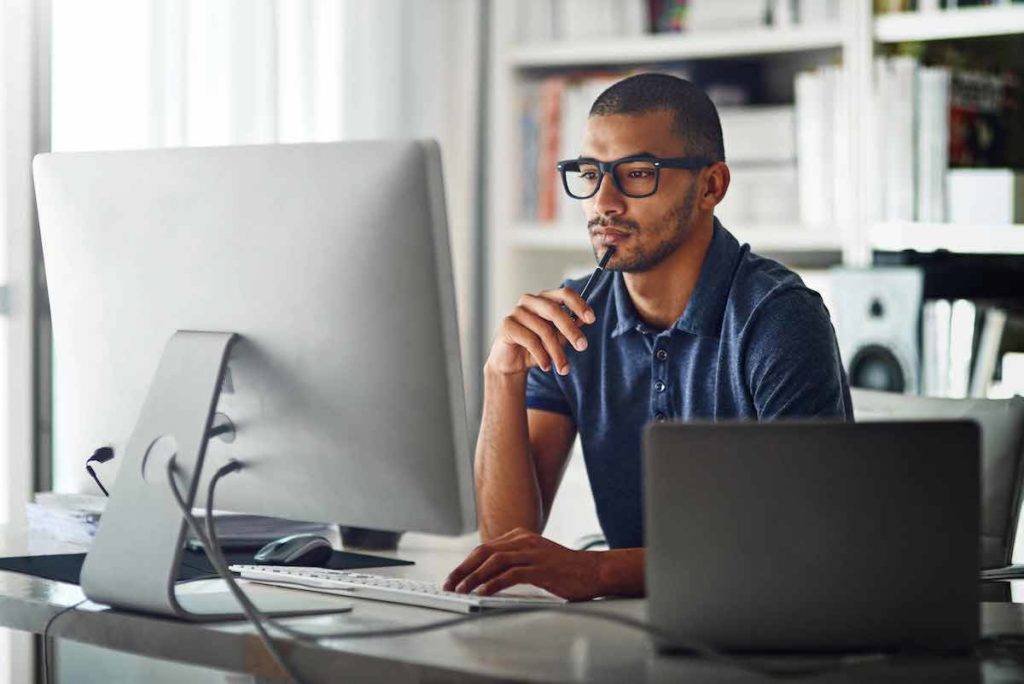 man working at a desktop computer