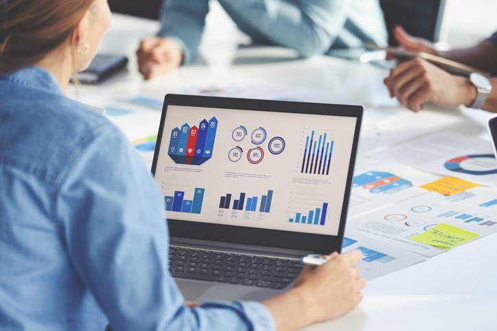 woman behind computer looking at analytics